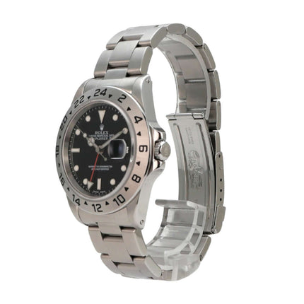 Rolex Explorer II Edelstahl 16570 Schwarz - Nahaufnahme des schwarzen Zifferblatts mit aufgesetzten Leuchtindizes und Leuchtpunkten.