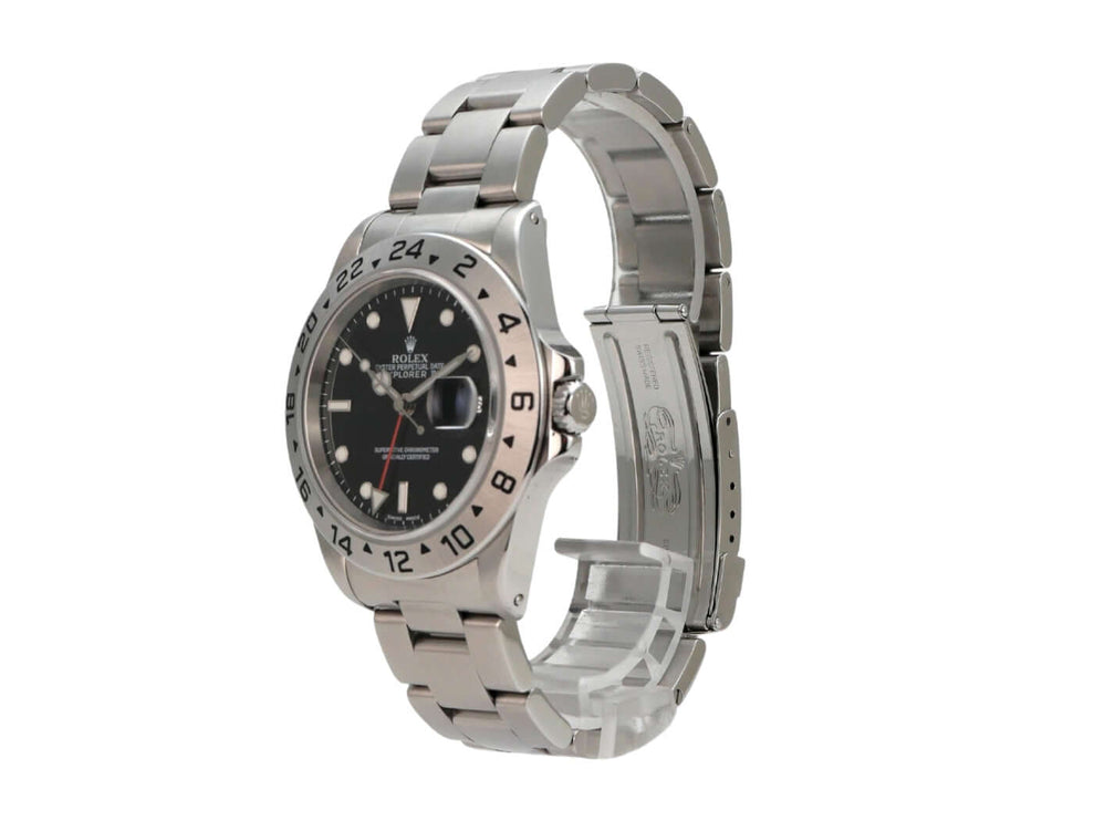 Rolex Explorer II Edelstahl 16570 Schwarz - Nahaufnahme des schwarzen Zifferblatts mit aufgesetzten Leuchtindizes und Leuchtpunkten.