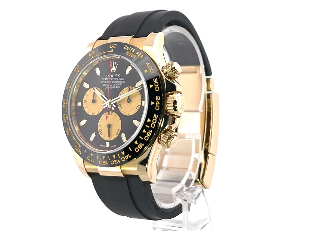 Rolex Daytona 116518LN Gelbgold mit schwarzem Oysterflex-Band, schwarz-champagnerfarbenes Zifferblatt und Keramik-Lünette, 40 mm Gehäuse.