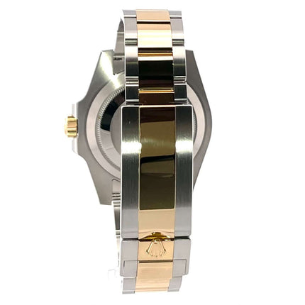 Nahaufnahme des Rolex Submariner Date 116613LB Armbandes aus Edelstahl und 18 kt Gelbgold mit polierten und satinierten Oberflächen.