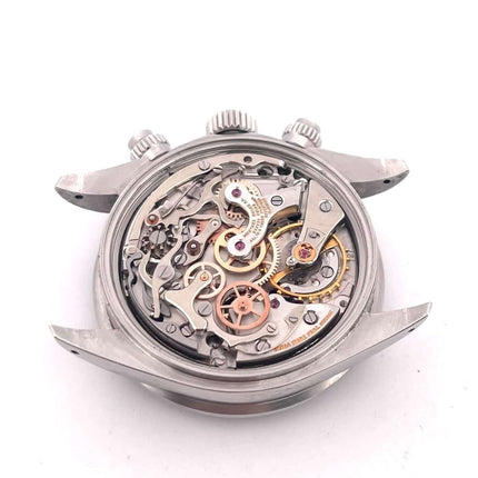 Uhrwerk des Rolex Daytona Edelstahl 6263, Vintage, Handaufzug, offene Rückseite mit sichtbaren Zahnrädern und Mechanismen.