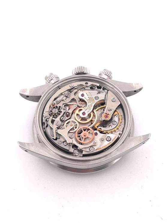 Uhrwerk des Rolex Daytona Edelstahl 6263, Vintage, Handaufzug, offene Rückseite mit sichtbaren Zahnrädern und Mechanismen.